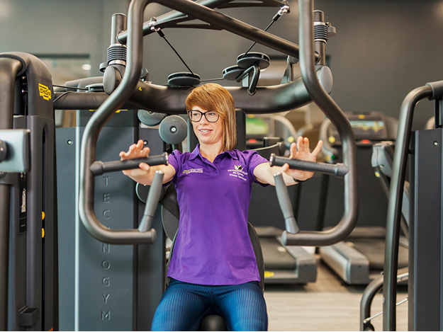 woman on fitness equipment in gym